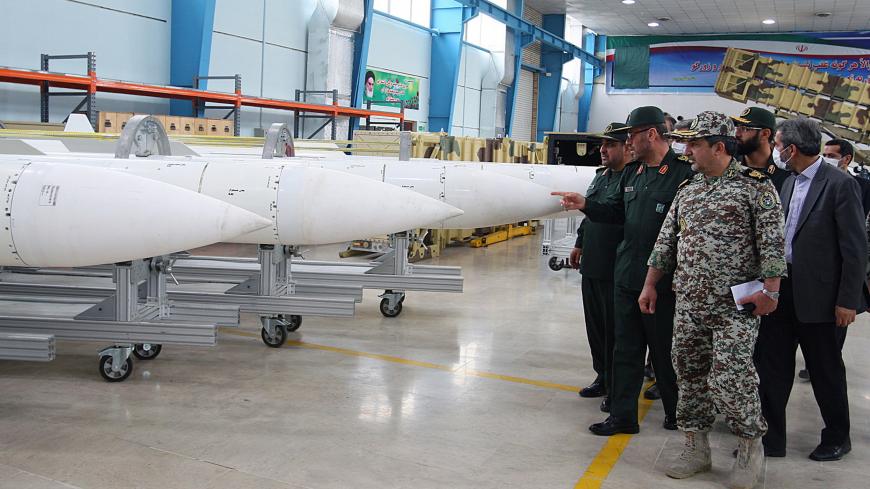 A picture obtained from Iran's ISNA news agency shows Iran's Defence Minister Hossein Dehqan (2nd L) pointing at an anti-missile system missiles of Sayyad-2 (Hunter 2), during the inauguration of it's production line in Tehran on November 9, 2013. Iran's Defence Minister Hossein Dehqan said that the solid-fuel missile system of Sayyad 2 is able to destroy different kinds of cruise missiles, bombers, drones and helicopters. AFP PHOTO/ISNA/STR        (Photo credit should read -/AFP via Getty Images)
