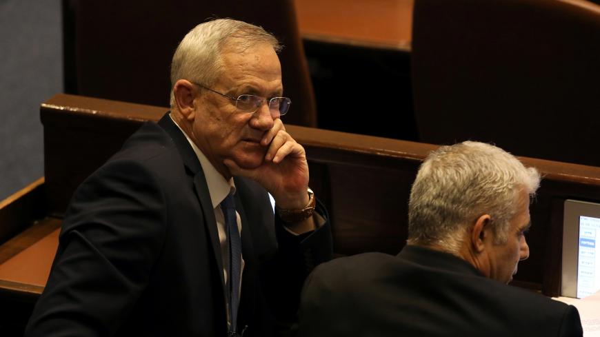 Benny Gantz, leader of Blue and White party, and Yair Lapid attend a parliamentary vote for its dissolution and approval of a date for a third national election in less than a year, at the Knesset, or Israel's parliament, in Jerusalem December 11, 2019. REUTERS/Ammar Awad - RC2ATD9IHGT9