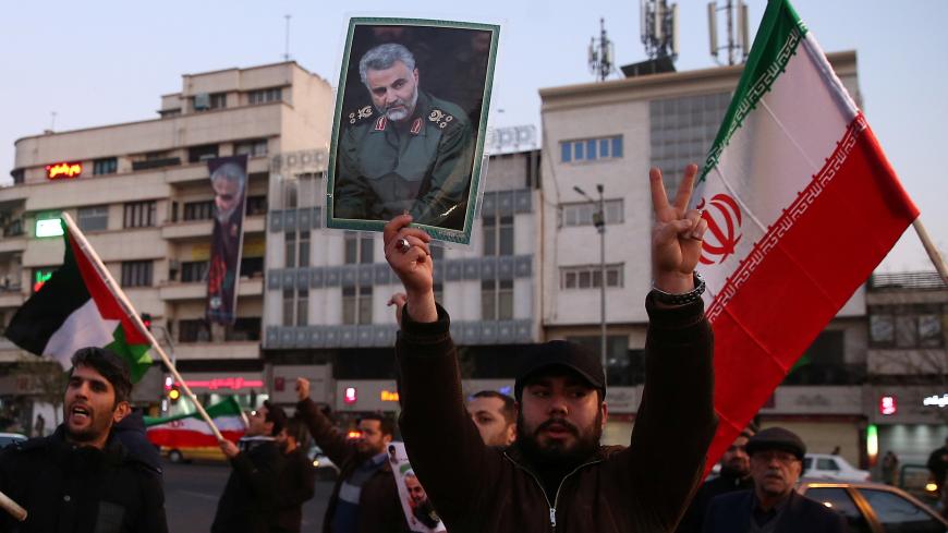 A man holds a picture of late Iranian Major-General Qassem Soleimani, as people celebrate in the street after Iran launched missiles at U.S.-led forces in Iraq, in Tehran, Iran January 8, 2020. Nazanin Tabatabaee/WANA (West Asia News Agency) via REUTERS ATTENTION EDITORS - THIS IMAGE HAS BEEN SUPPLIED BY A THIRD PARTY - RC2JBE917CLC