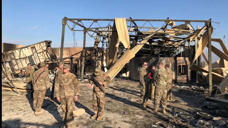 U.S. soldiers inspect the site where an Iranian missile hit at Ain al-Asad air base in Anbar province, Iraq January 13, 2020. REUTERS/John Davison - RC23FE9EJI5L