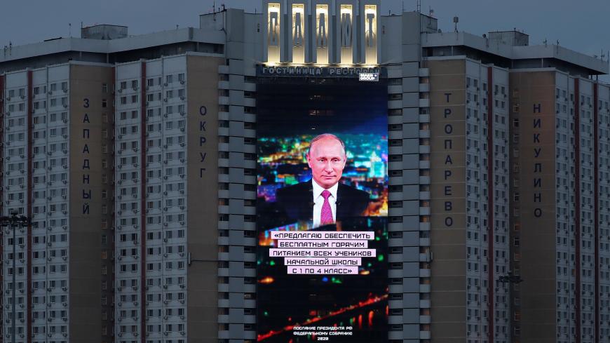 An electronic screen, installed on the facade of a hotel, shows an image of Russian President Vladimir Putin and a quote from his annual address to the Federal Assembly in Moscow, Russia January 15, 2020. The quote reads: "I propose to provide free hot meals to all elementary school students from grades 1 to 4 ". REUTERS/Evgenia Novozhenina - RC2EGE9T5QMD