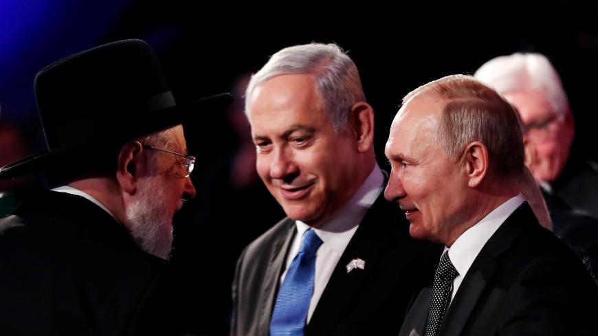 Rabbi Israel Meir Lau Chairman of the Yad Vashem Council speaks to Israeli Prime Minister Benjamin Netanyahu and Russian President Vladimir Putin at the World Holocaust Forum marking 75 years since the liberation of the Nazi extermination camp Auschwitz, at Yad Vashem Holocaust memorial centre in Jerusalem January 23, 2020. REUTERS/Ronen Zvulun/Pool - RC2RLE9EVQ76
