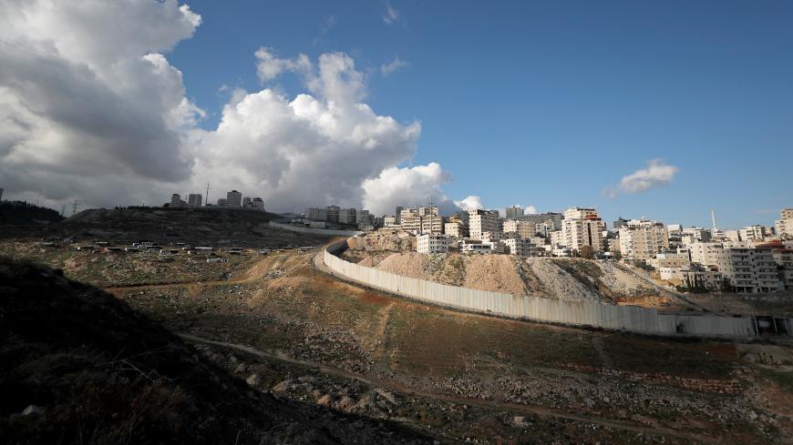 A general view picture shows the Israeli barrier running along the East Jerusalem refugee camp of Shuafat, in an area Israel annexed to Jerusalem after capturing it in the 1967 Middle East war, January 24, 2020. REUTERS/Ammar Awad - RC2GME9FFFI3