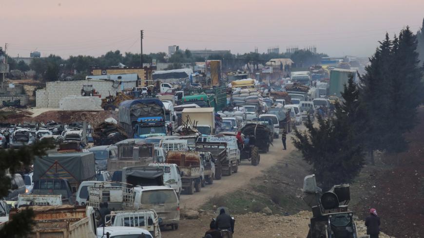 A general view of trucks carrying belongings of displaced Syrians, is pictured in the town of Sarmada in Idlib province, Syria, January 28, 2020. REUTERS/Khalil Ashawi - RC28PE9U8LCB