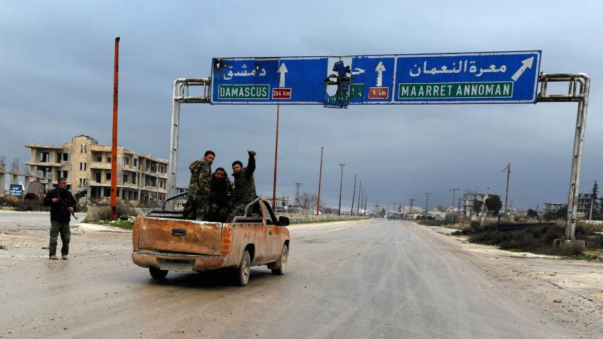 Syrian army soldiers gesture on the highway outside Maarat al-Numan, Syria, January 30, 2020.   REUTERS/Omar Sanadiki - RC2GQE9KJ096