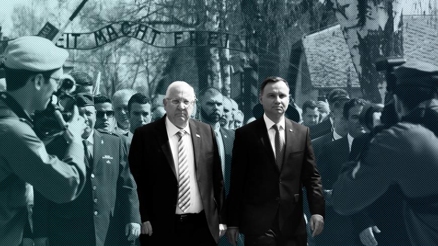 Polish President Andrzej Duda and Israeli President Reuven Rivlin are seen in front of the "Arbeit macht frei" (Work sets you free) gate as they take part in the annual "March of the Living" to commemorate the Holocaust at the former Nazi death camp Auschwitz, in Oswiecim, Poland, April 12, 2018.  REUTERS/Kacper Pempel - RC1EB00DCD80