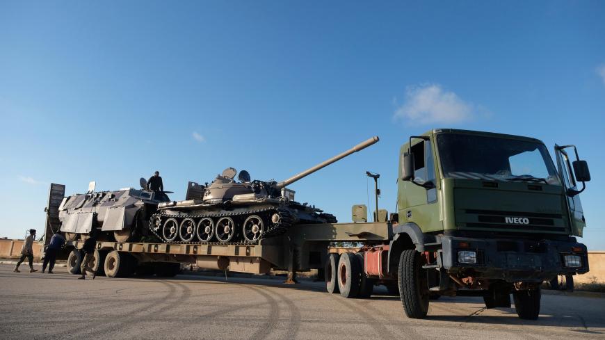 Libyan National Army (LNA) members, commanded by Khalifa Haftar, equip the military vehicles to get out of Benghazi to reinforce the troops advancing to Tripoli, in Benghazi, Libya April 13, 2019. REUTERS/Esam Omran Al-Fetori - RC1D53312530