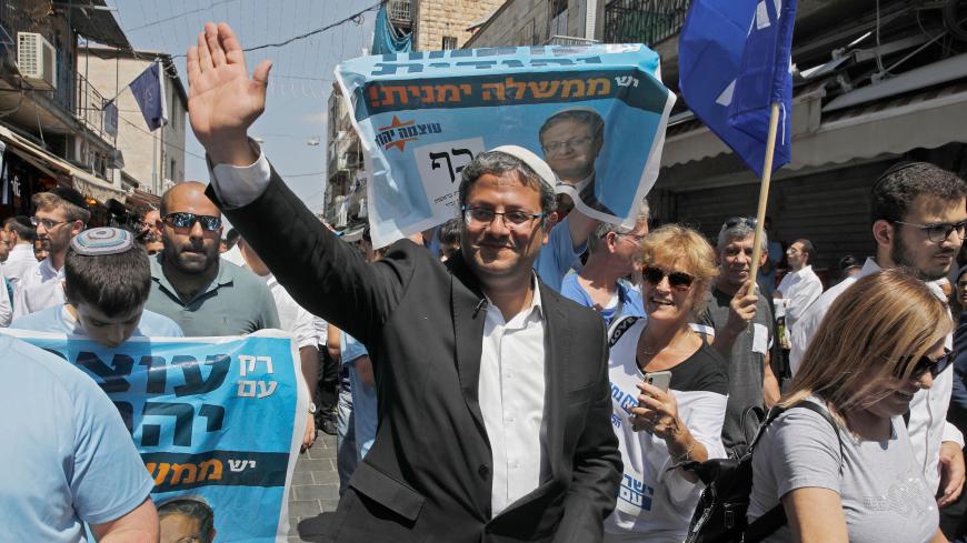 Leader of the far right 'Otzma Yehudit' (Jewish power) party Itamar Ben-Gvir waves as he marches with supporters at the Mahane Yehuda Market in Jerusalem on September 13, 2019. (Photo by MENAHEM KAHANA / AFP)        (Photo credit should read MENAHEM KAHANA/AFP via Getty Images)