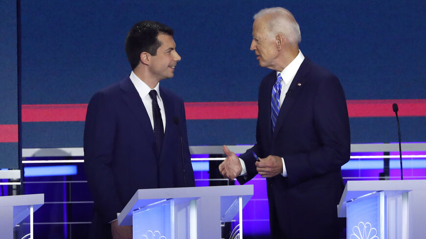South Bend Mayor Pete Buttigieg and former Vice President Joe Biden talk during a commercial break during the second night of the first Democratic presidential candidates debate in Miami, Florida, U.S. June 27, 2019. REUTERS/Mike Segar - HP1EF6S07RAKM