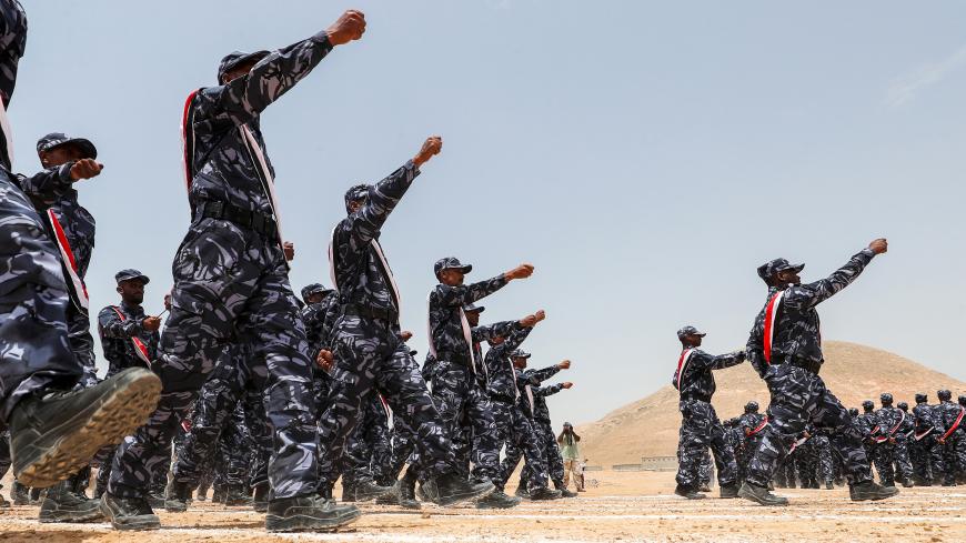 A picture taken on August 8, 2018 during a trip in Yemen organised by the UAE's National Media Council (NMC) shows UAE-trained cadets of the Yemeni police, supporting forces loyal to the Saudi and UAE-backed government, marching during their graduation in the southeastern port city of Mukalla, the capital Hadramawt province, in the first such ceremony after the city was retaken from Al-Qaeda jihadists. (Photo by KARIM SAHIB / AFP)        (Photo credit should read KARIM SAHIB/AFP via Getty Images)