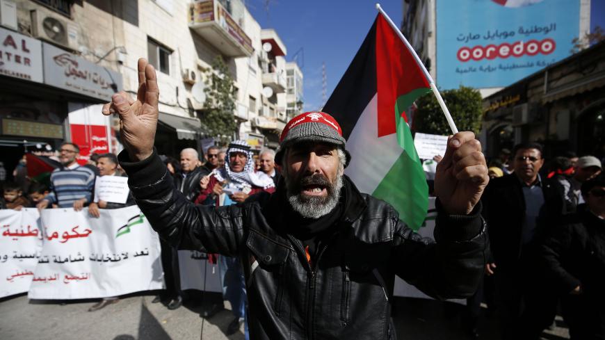 Palestinians wave national flags as they march in the streets of the occupied West Bank city of Ramallah, calling for the cessation of divisions between Fatah and Hamas and the unification of the West Bank and Gaza Strip, on January 12, 2019. (Photo by ABBAS MOMANI / AFP)        (Photo credit should read ABBAS MOMANI/AFP via Getty Images)