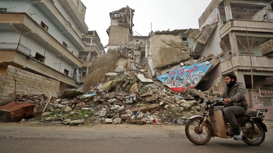 A Syrian man rides his motorcycle past a damaged building following an air strike by pro-regime forces on the rebel-held town of Ariha in the northern countryside of Syria's Idlib province on February 5, 2020. - Syrian regime forces pressed on with their offensive in the northwest that has displaced half a million people, despite heightened tensions with Turkey.
Intensive aerial bombardment and ground fighting in the jihadist-dominated Idlib region since December have killed almost 300 civilians and trigger
