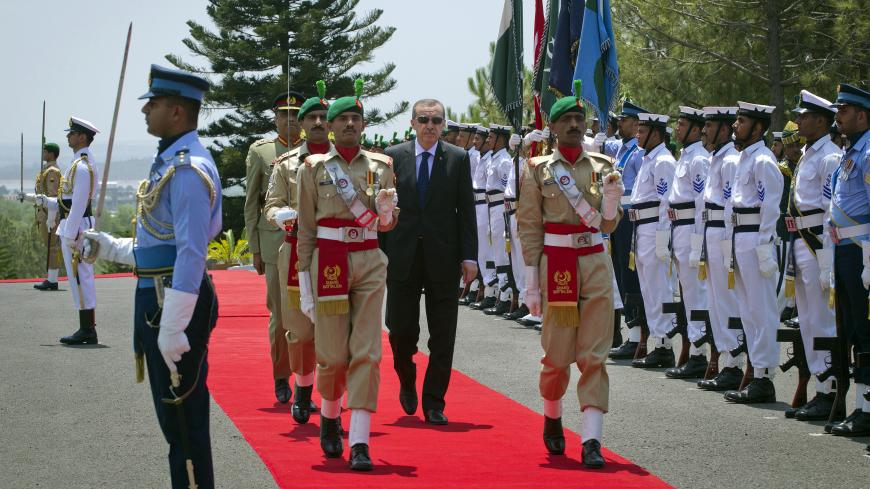 Turkish Prime Minister Tayyip Erdogan (C, wearing dark glasses) inspects an honour guard during a welcoming ceremony at the prime minister's residence in Islamabad May 22, 2012. Erdogan is in Islamabad on a three-day official visit to meet Pakistani leaders. REUTERS/Mian Khursheed  (PAKISTAN - Tags: POLITICS) - GM1E85M1HZ401