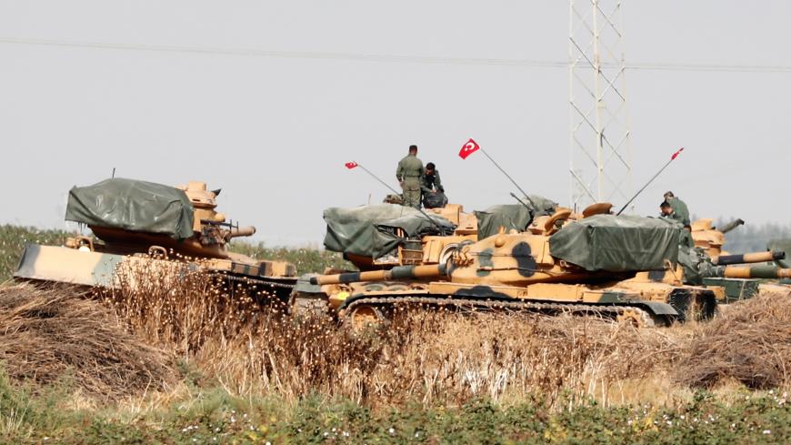 Turkish soldiers stand on top of tanks near the Turkish-Syrian border in Sanliurfa province, Turkey, October 15, 2019. REUTERS/Murad Sezer - RC163A321330