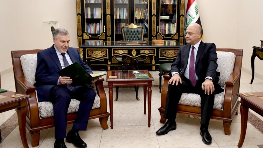 Iraq's President Barham Salih instructs newly appointed Prime Minister Mohammed Tawfiq Allawi, in Baghdad, Iraq February 1, 2020.  The Presidency of the Republic of Iraq Office/Handout via REUTERS ATTENTION EDITORS - THIS IMAGE WAS PROVIDED BY A THIRD PARTY. - RC2VRE9DWC79