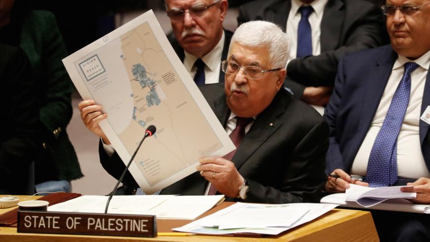 Palestinian President Mahmoud Abbas holds a map while speaking during a Security Council meeting at the United Nations in New York, U.S., February 11, 2020.  REUTERS/Shannon Stapleton - RC2FYE9OX8R2