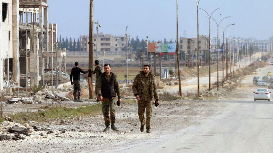 Syrian army soldiers walk along a street in Aleppo province, Syria, in this handout released by SANA on February 17, 2020.  SANA/Handout via REUTERS ATTENTION EDITORS - THIS IMAGE WAS PROVIDED BY A THIRD PARTY. REUTERS IS UNABLE TO INDEPENDENTLY VERIFY THIS IMAGE - RC2K2F9QWRFR
