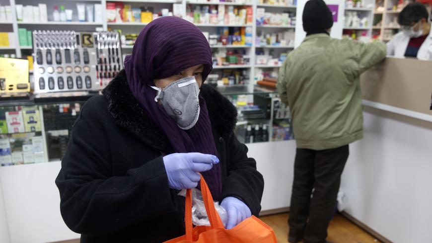 An Iranian woman wears a protective mask to prevent contracting coronavirus, as she is seen at a drug store in Tehran, Iran February 25, 2020. WANA (West Asia News Agency)/Nazanin Tabatabaee via REUTERS ATTENTION EDITORS - THIS IMAGE HAS BEEN SUPPLIED BY A THIRD PARTY. - RC2Q7F9XS5BN