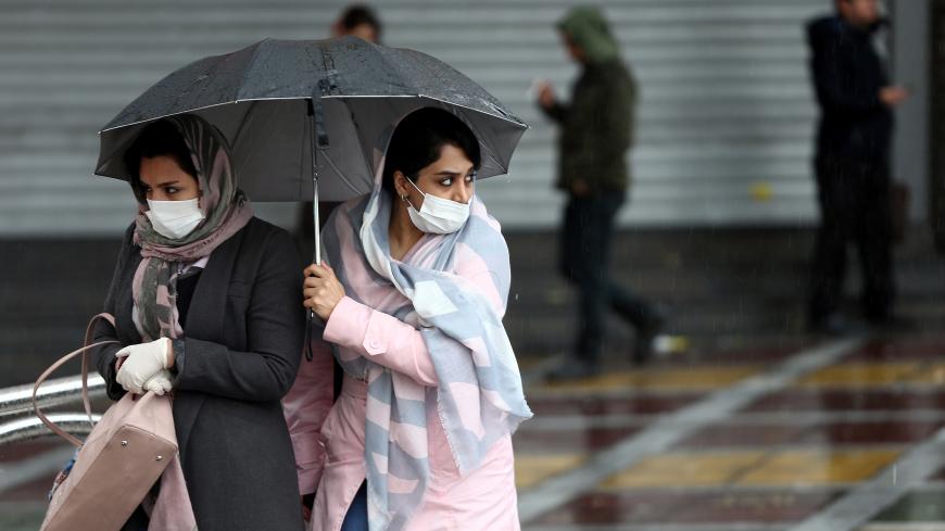 Iranian women wear protective masks to prevent contracting coronavirus, as they walk in the street in Tehran, Iran February 25, 2020. WANA (West Asia News Agency)/Nazanin Tabatabaee via REUTERS ATTENTION EDITORS - THIS IMAGE HAS BEEN SUPPLIED BY A THIRD PARTY. - RC2Q7F9UZ1JB