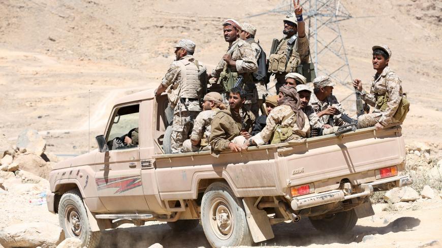 Pro-government army soldiers ride on the back or a truck in Fardhat Nahm area, which has recently been taken by the army from Houthi rebels around 60km (40 miles) from Yemen's capital Sanaa, February 20, 2016. REUTERS/Ali Owidha - GF10000316618