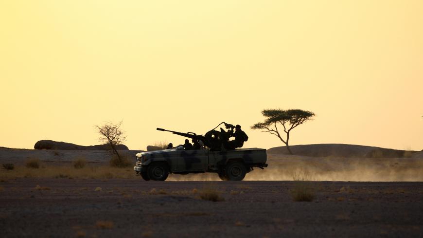 The Polisario Front soldiers drive a pick-up truck mounted with an anti-aircraft weapon during sunset in Bir Lahlou, Western Sahara, September 9, 2016. REUTERS/Zohra Bensemra          SEARCH ìPOLISARIOî FOR THIS STORY. SEARCH "WIDER IMAGE" FOR ALL STORIES.     - S1BEUKRIISAA