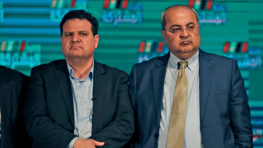 Ayman Odeh (L), leader of the Hadash party that is part of the Joint List alliance, stands next to Ahmed Tibi of the Arab Movement for Change (Ta'al) party, as they and other alliance leaders address supporters at their electoral headquarters in Israel's northern city of Shefa-Amr on March 2, 2020, after polls officially closed. - Israeli Prime Minister Benjamin Netanyahu appeared to lead his main challenger following elections with multiple exit polls putting his right-wing Likud several seats ahead of the