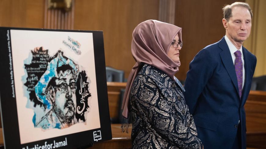Hatice Cengiz, slain Washington Post columnist Jamal Khashoggi's fiancee, stands alongside US Senator Ron Wyden, Democrat of Oregon, during a press conference calling for the Trump administration to release details about his killing, on Capitol Hill in Washington, DC, March 3, 2020. (Photo by SAUL LOEB / AFP) (Photo by SAUL LOEB/AFP via Getty Images)