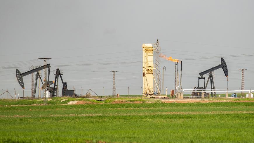 Pump jacks operate in an oil field in the countryside of al-Qahtaniyah town in Syria's northeastern Hasakeh province near the Turkish border, on March 11, 2020. (Photo by Delil SOULEIMAN / AFP) (Photo by DELIL SOULEIMAN/AFP via Getty Images)