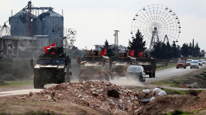 A Turkish military convoy drives along the M4 highway, which links the northern Syrian provinces of Aleppo and Latakia, near the village of al-Nayrab, about 14 kilometres southeast of Idlib city and seven kilometres west of Saraqib in northwestern Syria on March 25, 2020. (Photo by OMAR HAJ KADOUR / AFP) (Photo by OMAR HAJ KADOUR/AFP via Getty Images)