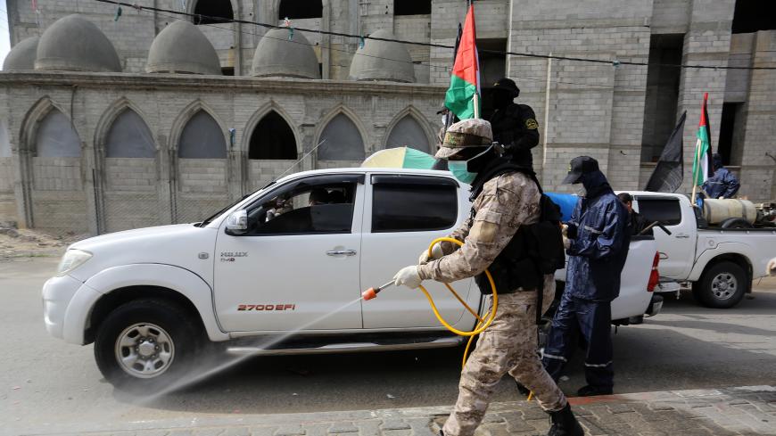RAFAH, GAZA â MARCH 26: Members of Saraya al-Quds, armed wing of the Palestinian Islamic Jihad, carry out disinfection works as a preventive measure against the coronavirus (COVID-19) pandemic in Rafah, Gaza on March 26, 2020. (Photo by Abed Rahim Khatib/Anadolu Agency via Getty Images)