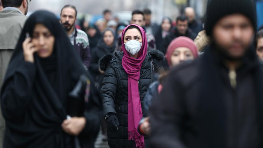 An Iranian woman wearing a protective mask to prevent contracting a coronavirus walks at Grand Bazaar in Tehran, Iran February 20, 2020. WANA (West Asia News Agency)/Nazanin Tabatabaee via REUTERS ATTENTION EDITORS - THIS IMAGE HAS BEEN SUPPLIED BY A THIRD PARTY. - RC2D4F92XR0E