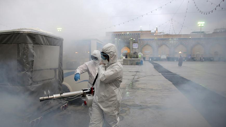 Members of the medical team spray disinfectant to sanitize outdoor place of Imam Reza's holy shrine, following the coronavirus outbreak, in Mashhad, Iran February 27, 2020. Picture taken February 27, 2020. WANA (West Asia News Agency) via REUTERS ATTENTION EDITORS - THIS PICTURE WAS PROVIDED BY A THIRD PARTY - RC2FAF9ALELI