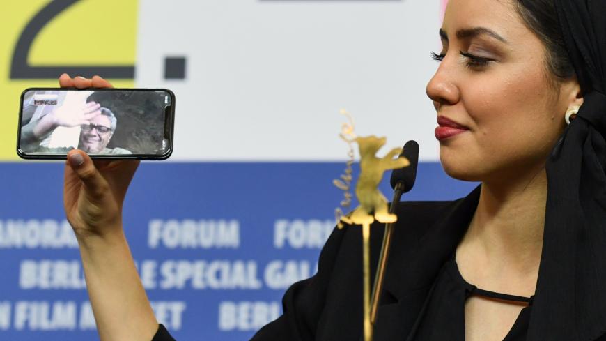 Director Mohammad Rasoulof, winner of the Golden Bear for Best Film for "There Is No Evil", speaks through a video call as his daughter Baran Rasoulof holds a cellphone, during a news conference after the award ceremony of the 70th Berlinale International Film Festival in Berlin, Germany February 29, 2020. REUTERS/Annegret Hilse - UP1EG2T1OP7IV