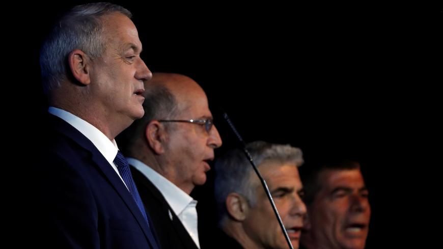 Blue and White party leader Benny Gantz stands next to his party co-leaders Moshe Yaalon, Yair Lapid and Gaby Ashkenazi as he speaks to supporters following the announcement of exit polls in Israel's election at the party's headquarters in Tel Aviv, Israel March 3, 2020. REUTERS/Ronen Zvulun - RC20CF9OD5IB