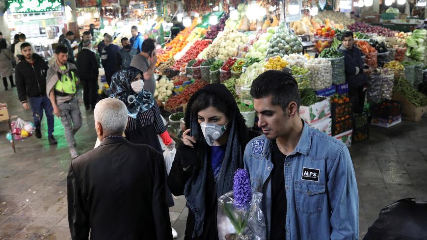 An Iranian woman wears a protective face mask, amid fear of coronavirus disease (COVID-19), as she shops at Tajrish Bazar, ahead of the Iranian New Year Nowruz, March 20, in Tehran, Iran March 18, 2020. Picture taken March 18, 2020. WANA (West Asia News Agency)/Ali Khara via REUTERS ATTENTION EDITORS - THIS PICTURE WAS PROVIDED BY A THIRD PARTY - RC22NF96FTGC