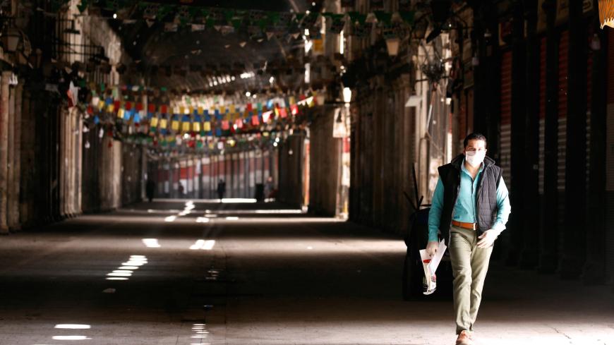 A man walks in empty Souk al-Hamidieh as restrictions are imposed as measure to prevent the spread of the coronavirus disease (COVID-19) in Damascus, Syria March 24, 2020. REUTERS/Omar Sanadiki - RC2HQF96TEGY