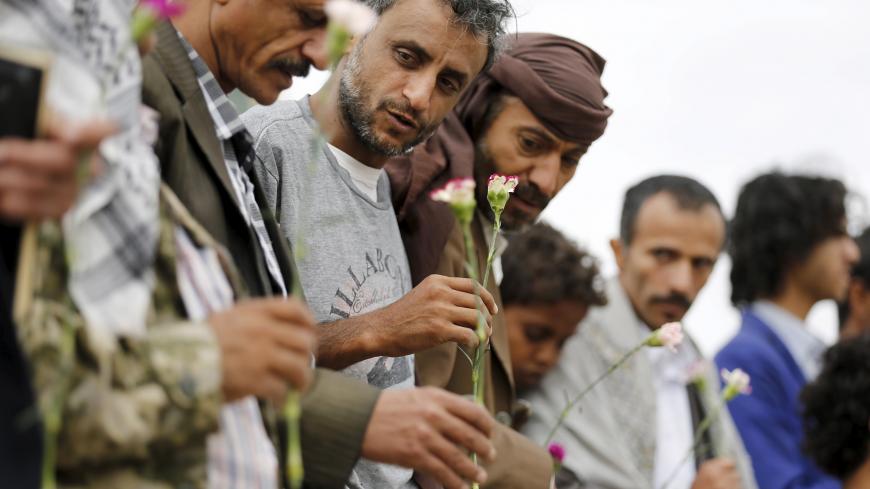 Members of the Baha'i faith hold flowers as they demonstrate outside a state security court during a hearing in the case of a fellow Baha'i man charged with seeking to establish a base for the community in Yemen, in the country's capital Sanaa April 3, 2016. REUTERS/Khaled Abdullah - GF10000369865