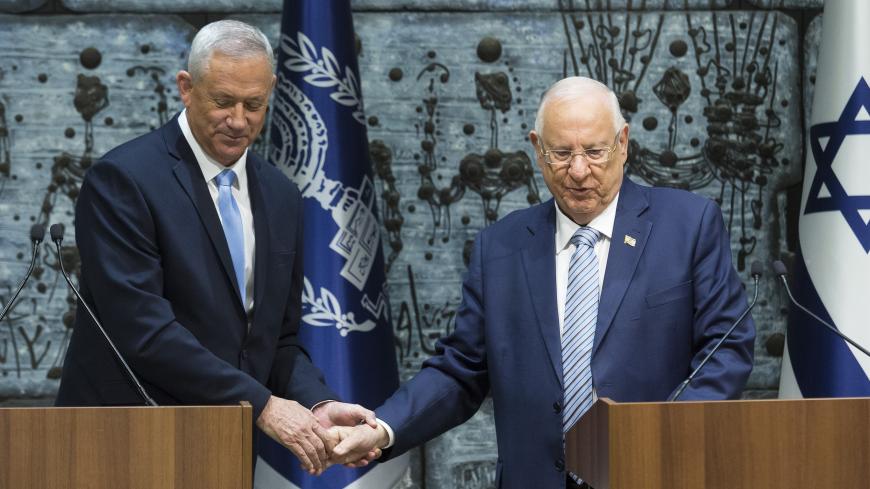 JERUSALEM, ISRAEL - OCTOBER 23: Israeli President Reuven Rivlin (R) and Blue and White Party Leader Benny Gantz shake hands during a nomination ceremony on October 23, 2019 in Jerusalem, Israel. Gantz has received a mandate to form a government after Israeli Prime Minister Benjamin Netanyahu failed to form a coalition. (Photo by Amir Levy/Getty Images)