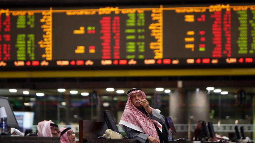 Kuwaiti traders follow stock prices at Boursa Kuwait stock market, in Kuwait City on January 6, 2020. - Gulf stock markets were hit by a panicky sell-off amid Iranian vows of retaliation over the US killing of top military commander Qasem Soleimani, with all seven markets in the Gulf Cooperation Council (GCC) states closing in the red on the first trading day since the US attack. (Photo by YASSER AL-ZAYYAT / AFP) (Photo by YASSER AL-ZAYYAT/AFP via Getty Images)