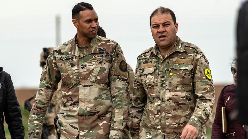 US Army Colonel Myles Caggins (L), official military spokesperson for international military intervention against the Islamic State (IS), and Syrian Democratic Forces (SDF) media spokesman Mustafa Bali (R), visit a military base in Rumaylan (Rmeilan) in Syria's northeastern Hasakeh province on March 6, 2020. (Photo by Delil SOULEIMAN / AFP) (Photo by DELIL SOULEIMAN/AFP via Getty Images)