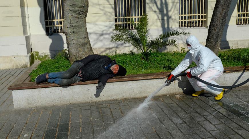 A member of the Fatih Municipality disinfects the Sultanahmet square in Istanbul to prevent the spread of the novel coronavirus (COVID-19) on March 21, 2020. - The religious affairs authority, Diyanet, ordered the closure of around 90,000 mosques in Turkey on March 20, the day of particularly important prayers in the Muslim faith. (Photo by BULENT KILIC / AFP) (Photo by BULENT KILIC/AFP via Getty Images)