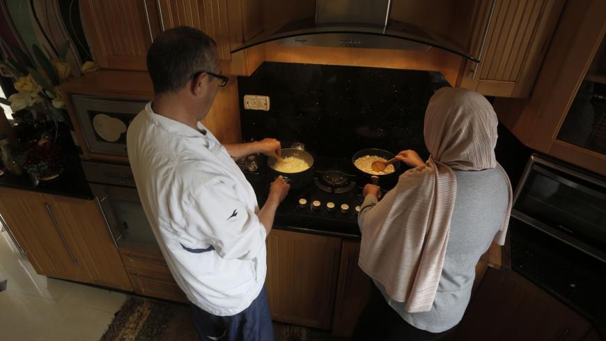 NABLUS, March 30, 2020 .Palestinian chef Hasan Titi, 56, helps his wife Samar Titi in cooking and preparing homemade meal inside their house kitchen in the West Bank city of Nablus, March 30, 2020. Normally, it's the women who do the cooking and kitchen chores in Palestine. However, this is changing amid a lockdown imposed to prevent the spread of COVID-19, or novel coronavirus. 
TO GO WITH "Feature: Coronavirus lockdown brings Palestinian men into kitchen" (Photo by Ayman Nobani/Xinhua via Getty) (Xinhua/ 
