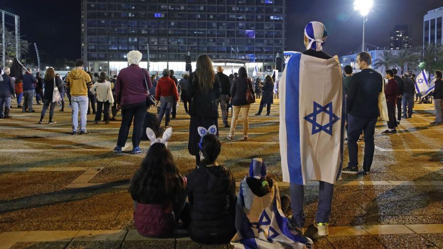 Israelis take part in a demonstration on April 25, 2020, in Rabin Square in the coastal city of Tel Aviv, to protest what they consider threats to Israeli democracy, against the backdrop of negotiations between Prime Minister Benjamin Netanyahu and his ex-rival Benny Gantz. - The protesters stood two meters apart from each other, thereby respecting the social distancing measures in force to fight the COVID-19 pandemic. (Photo by JACK GUEZ / AFP) (Photo by JACK GUEZ/AFP via Getty Images)