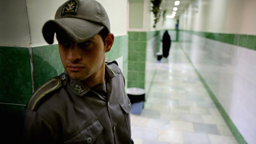 A prison guard stands along a corridor in Tehran's Evin prison June 13, 2006. Iranian police detained 70 people at a demonstration in favour of women's rights, the judiciary said on Tuesday, adding it was ready to review reports that the police had beaten some demonstrators.  REUTERS/Morteza Nikoubazl (IRAN) - GM1DSVACJVAA
