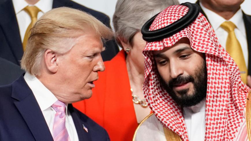 U.S. President Donald Trump speaks with Saudi Arabia's Crown Prince Mohammed bin Salman during family photo session with other leaders and attendees at the G20 leaders summit in Osaka, Japan, June 28, 2019.  REUTERS/Kevin Lamarque     TPX IMAGES OF THE DAY - RC1A069AC350