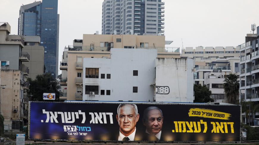A Blue and White party election campaign poster, depicting party leader Benny Gantz, and Israeli Prime Minister Benjamin Netanyahu, is seen in Tel Aviv, Israel February 18, 2020. REUTERS/Amir Cohen - RC243F9OLAV7