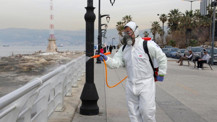 Employees from a disinfection company sanitize handrails, as a precaution against the spread of the coronavirus, at Beirut's seaside Corniche, Lebanon March 5, 2020. REUTERS/Mohamed Azakir - RC2SDF9YPMAO