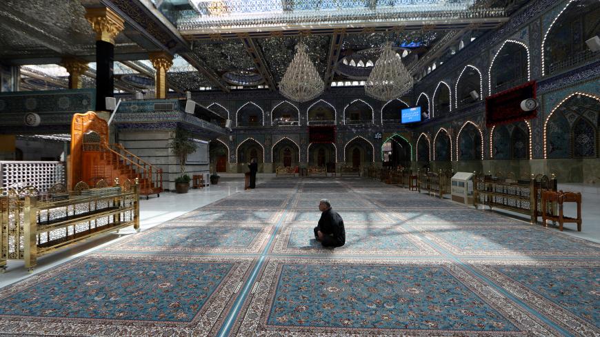 A man sits inside empty Imam Abbas shrine, as Friday prayers were suspended following the spread of the coronavirus disease (COVID-19), in the holy city of Kerbala , Iraq, March 20, 2020. REUTERS/Abdullah Dhiaa al-Deen - RC2LNF9OG4S6
