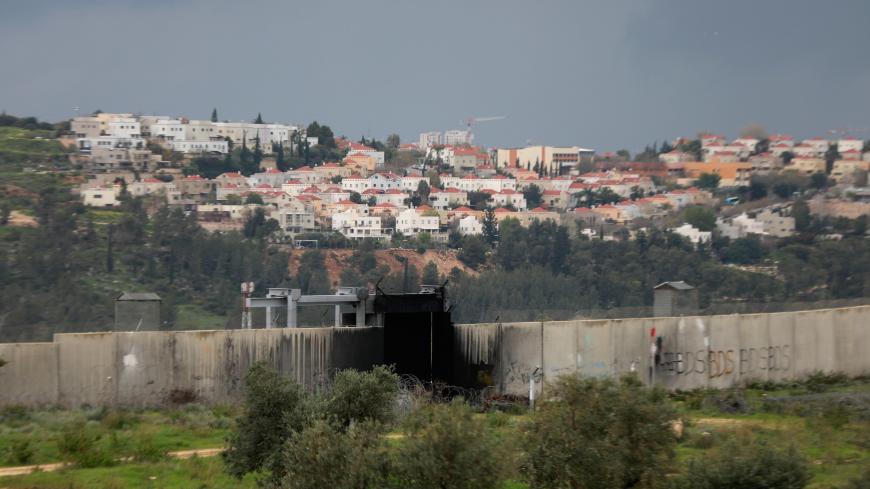 A view shows the Jewish settlement of Modiin Illit in the background and the Israeli barrier in the foreground in the village of Bilin, where a Friday anti-Israel weekly protest is held, as the area is seen empty of Palestinian demonstrators amid concerns of the spread of the coronavirus disease, in the Israeli-occupied West Bank March 20, 2020. REUTERS/Mohamad Torokman - RC2PNF9HQOZQ
