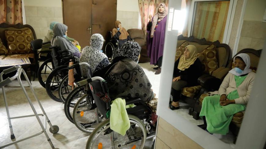 Elderly Palestinian women are reflected in a mirror during an awareness lesson on coronavirus disease (COVID-19) in a nursing house that stepped up preventive measures to protect the patients, in Jenin in the Israeli-occupied West Bank, April 2, 2020. REUTERS/Raneen Sawafta - RC2CWF9971N2